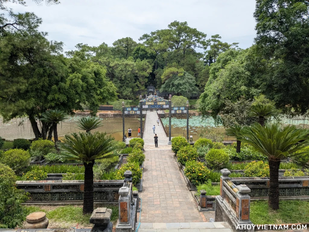 Tourists walking the pathway across a lake